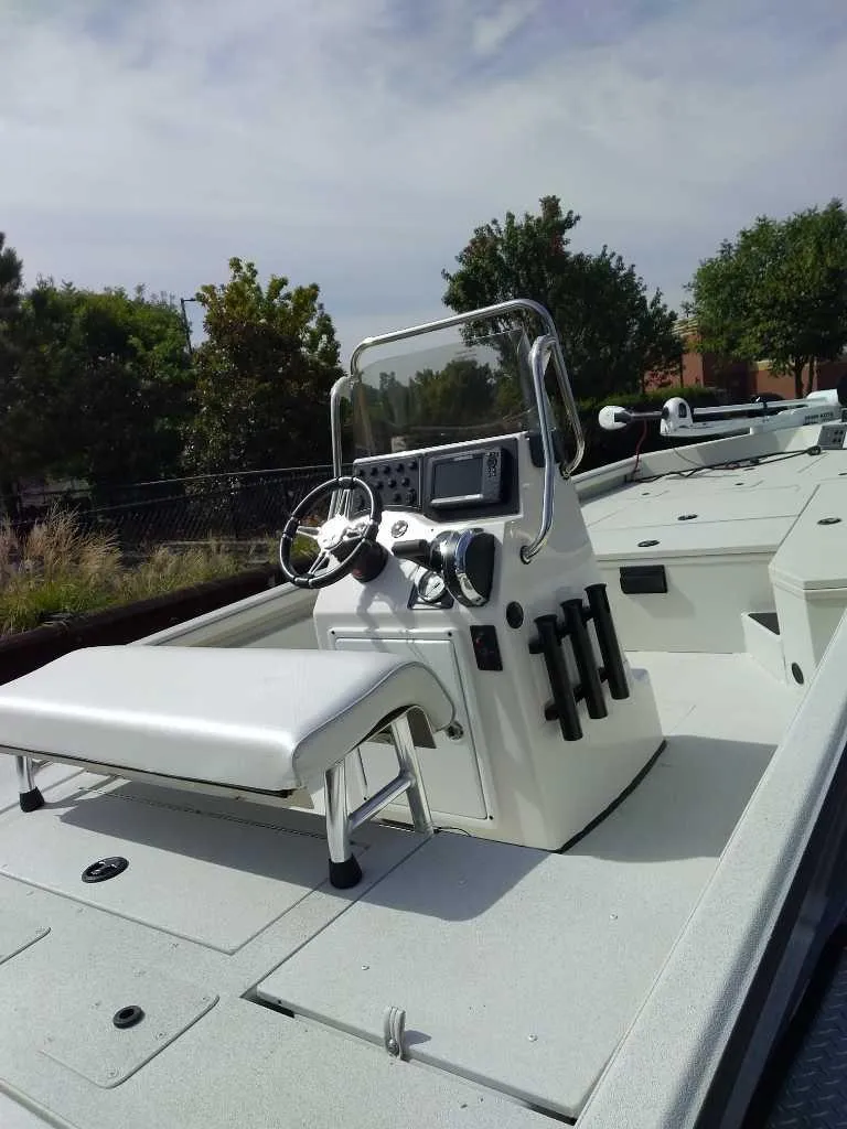 Slide: The Image of 2024 Ranger RB200 boat with steering console and seating, outdoors. - 3