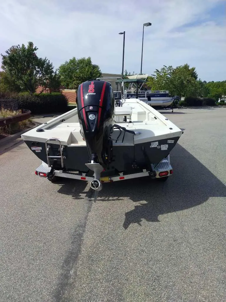 Slide: The Image of 2024 Ranger RB200 boat with outboard motor on a trailer in a parking lot. - 4