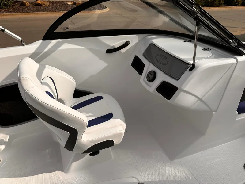 Slide: The Image of 2024 Tahoe 185 S boat interior with white and blue seating and dashboard. - 11