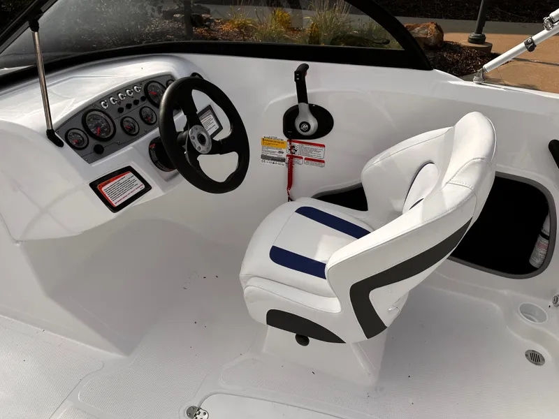 Slide: The Image of 2024 Tahoe 185 S boat interior with steering wheel and captain's chair. - 12