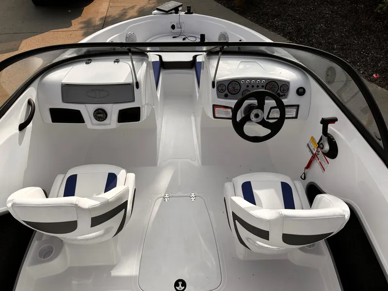Slide: The Image of 2024 Tahoe 185 S boat interior with dual seats and steering console. - 4