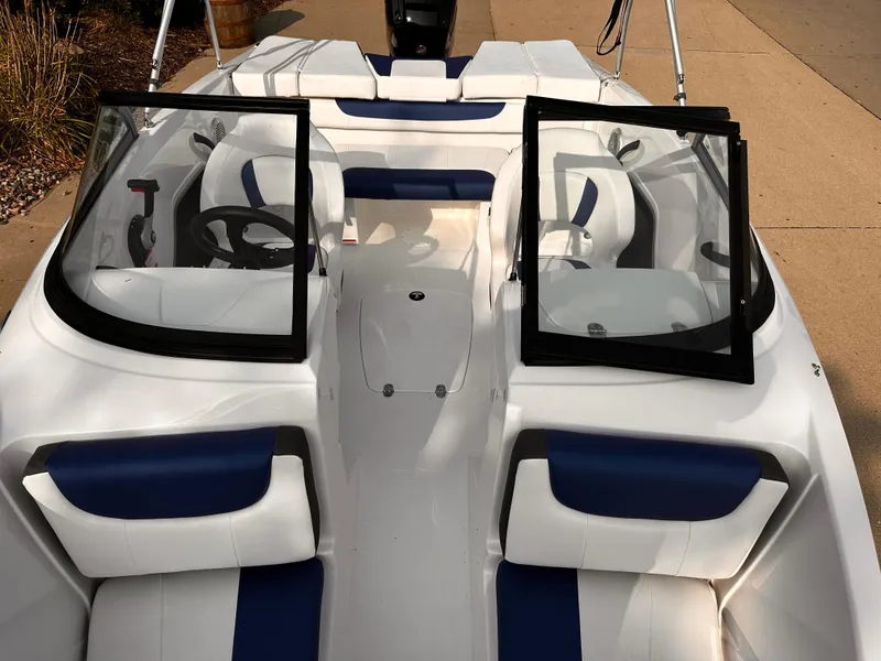 Slide: The Image of 2024 Tahoe 185 S boat interior with blue and white seating and open windshield. - 5