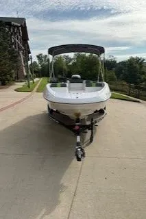 Slide: The Image of 2024 Tahoe T16 boat on driveway, surrounded by greenery and a house. - 2