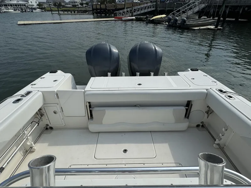Slide: The Image of Edgewater 318 CC 2013 boat interior with dual engines, docked by the water. - 10