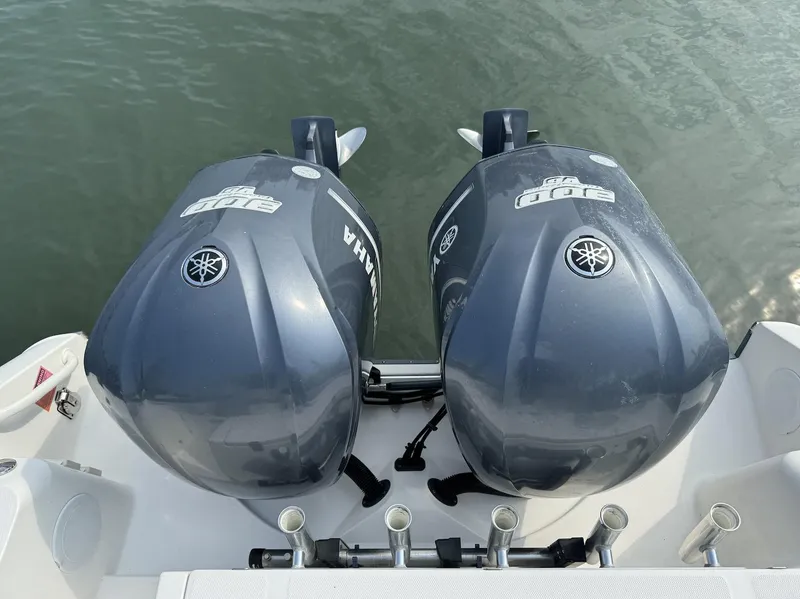 Slide: The Image of Twin Yamaha outboard engines on a 2013 Edgewater 318 CC boat. - 12