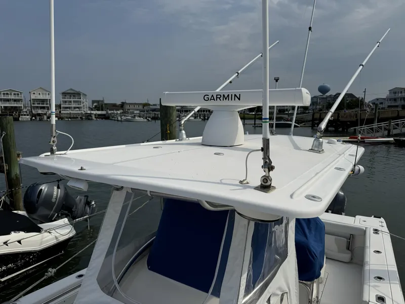 Slide: The Image of 2013 Edgewater 318 CC boat with Garmin equipment docked at marina. - 5