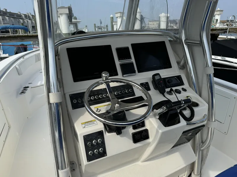 Slide: The Image of 2013 Edgewater 318 CC boat console with steering wheel and navigation equipment. - 6