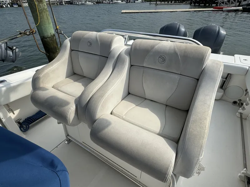 Slide: The Image of 2013 Edgewater 318 CC boat seats with waterfront view. - 7
