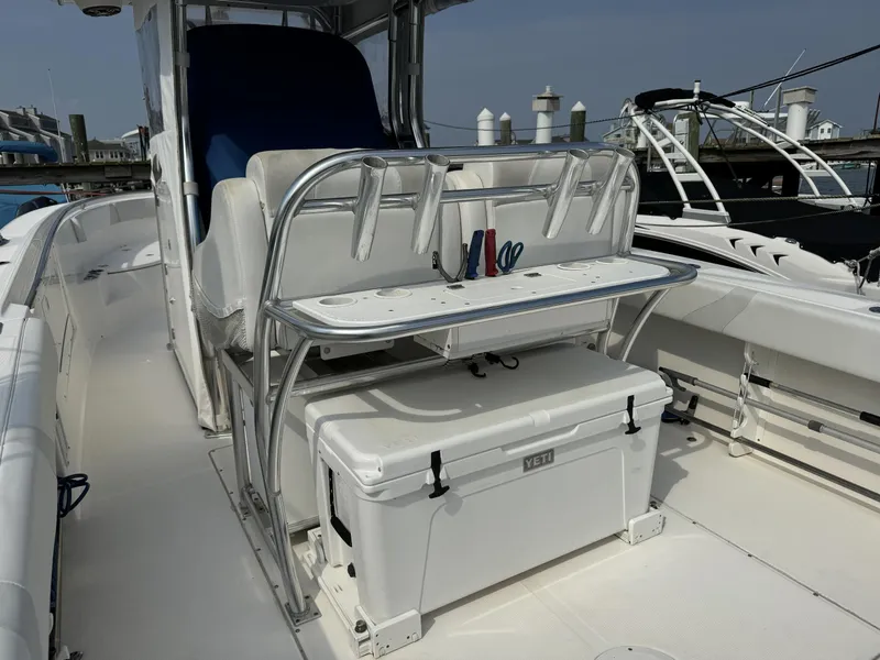 Slide: The Image of 2013 Edgewater 318 CC boat interior with seating and Yeti cooler. - 9