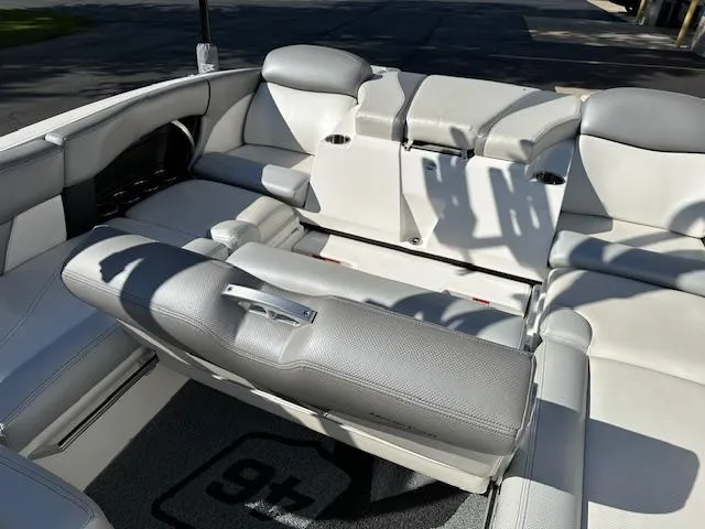 Slide: The Image of 2016 MasterCraft X46 boat interior with gray seating and cup holders. - 14