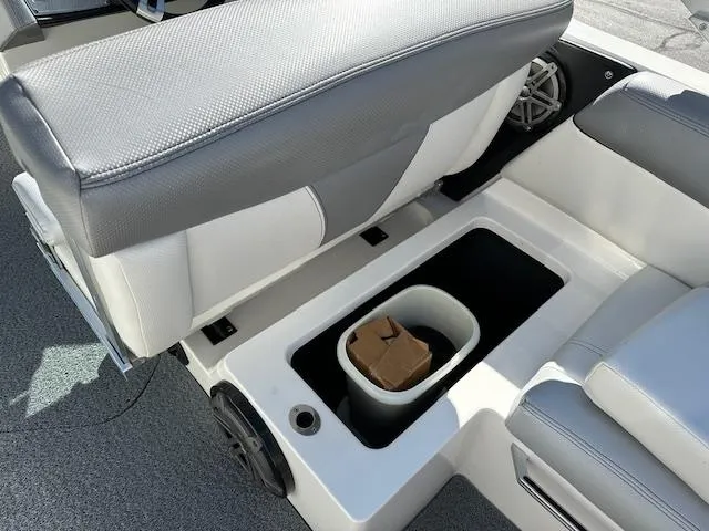 Slide: The Image of 2016 MasterCraft X46 boat interior storage compartment with seating and speaker. - 27