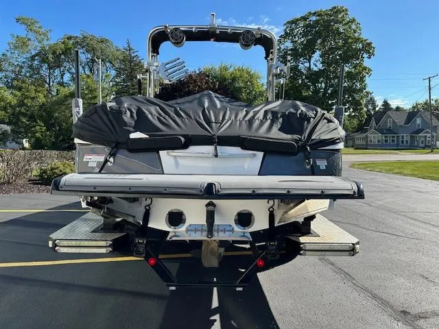 Slide: The Image of 2016 MasterCraft X46 boat, rear view, covered, parked on asphalt. - 30