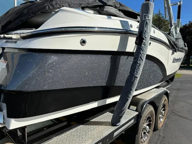 Slide: The Image of 2016 MasterCraft X46 boat on trailer, black and white design, parked outdoors. - 32