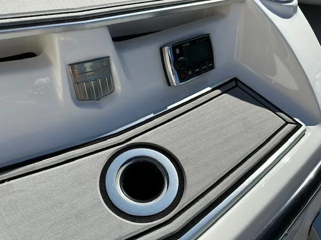 Slide: The Image of 2016 MasterCraft X46 boat dashboard with cup holder and control panel. - 33