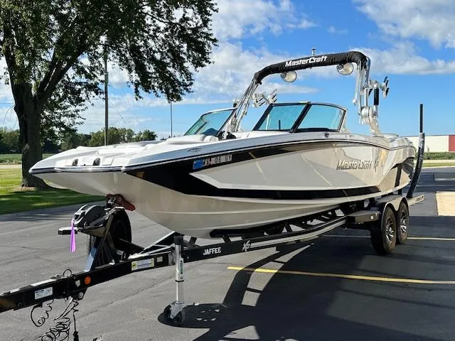 Slide: The Image of 2016 MasterCraft X46 boat on trailer in sunny outdoor setting. - 4
