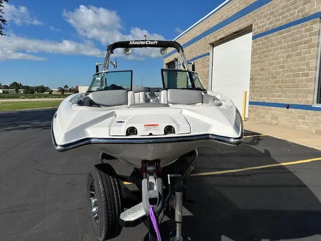 Slide: The Image of 2016 MasterCraft X46 boat on trailer, parked outside a building. - 5