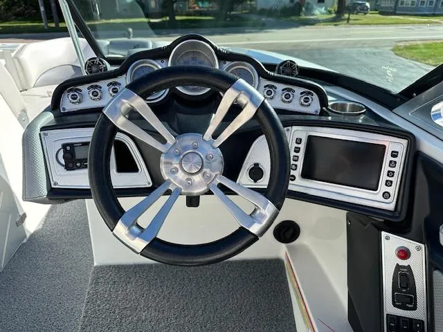 Slide: The Image of 2016 MasterCraft X46 boat dashboard with steering wheel and control panel. - 8