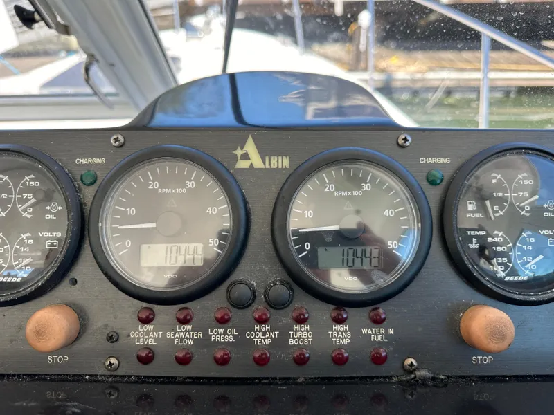 Slide: The Image of Dashboard of a 2005 Albin Tournament Express boat with gauges and indicators. - 13