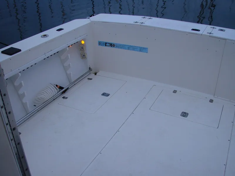 Slide: The Image of 2005 Albin Tournament Express boat deck, spacious and clean, with storage compartments. - 20