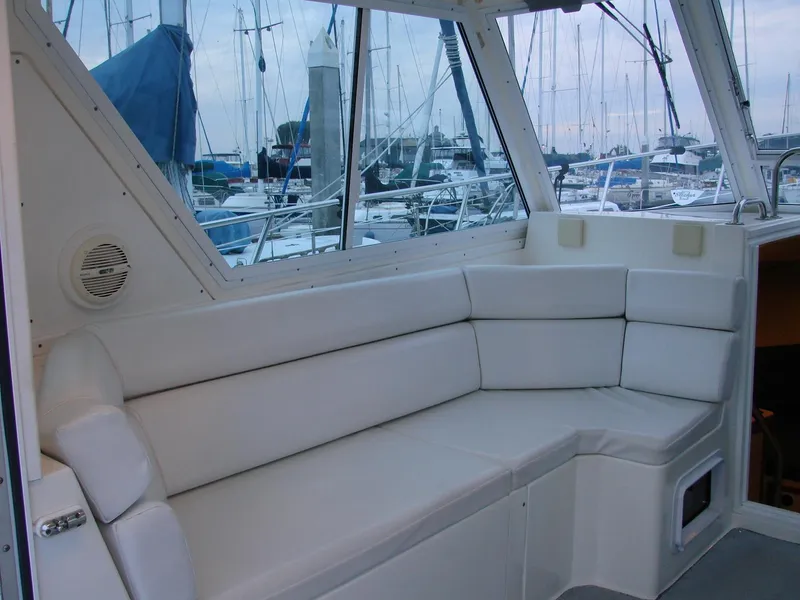 Slide: The Image of 2005 Albin Tournament Express interior with white seating, docked at marina. - 25