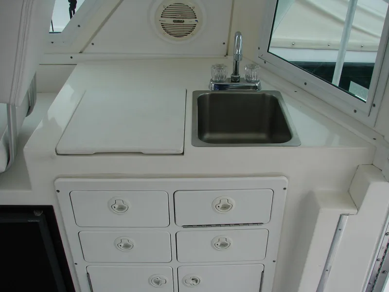Slide: The Image of 2005 Albin Tournament Express boat interior with sink and storage drawers. - 26
