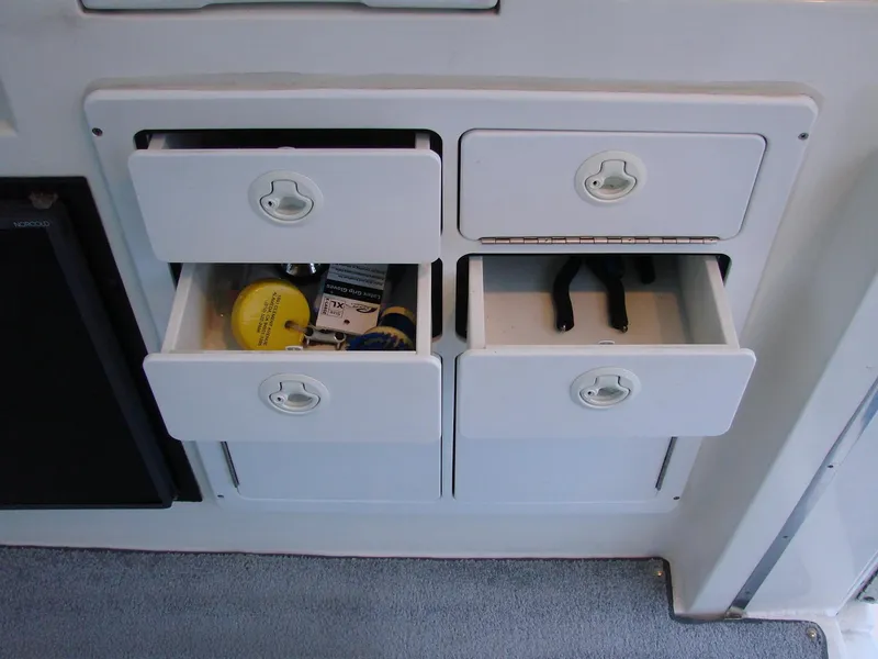 Slide: The Image of Storage drawers on a 2005 Albin Tournament Express boat, containing tools and accessories. - 27
