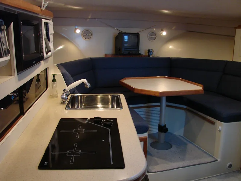 Slide: The Image of 2005 Albin Tournament Express interior with kitchenette and seating area. - 30