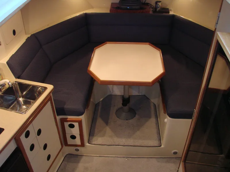 Slide: The Image of 2005 Albin Tournament Express cabin interior with dining area and kitchenette. - 32