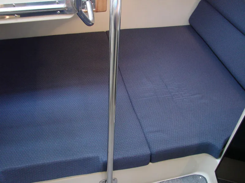 Slide: The Image of 2005 Albin Tournament Express interior seating with blue cushions and metal railing. - 36
