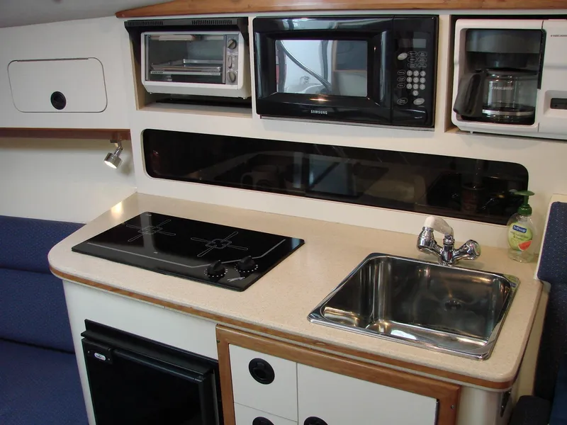 Slide: The Image of 2005 Albin Tournament Express kitchen with stove, sink, microwave, and coffee maker. - 39
