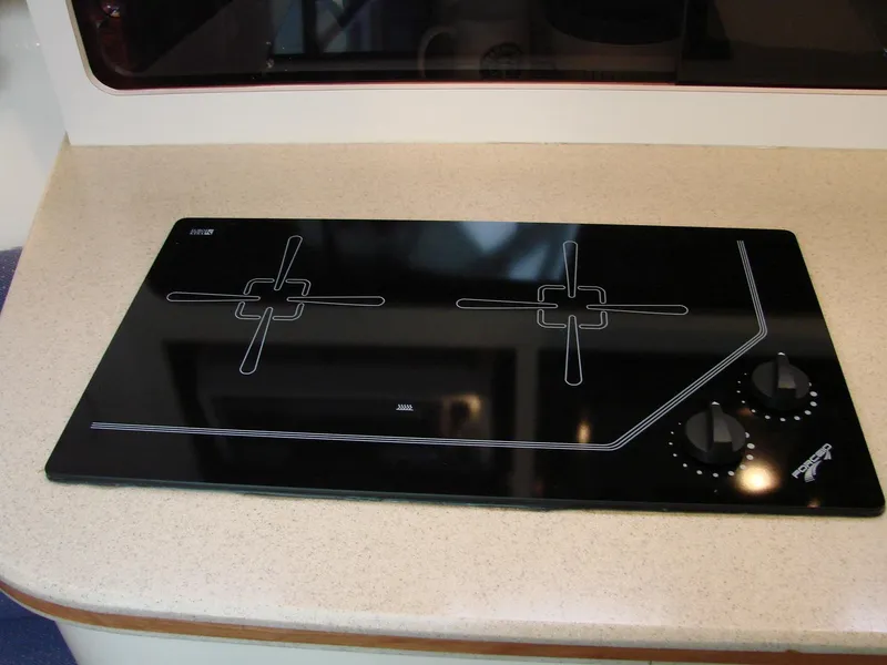 Slide: The Image of 2005 Albin Tournament Express stovetop with black glass surface and control knobs. - 40