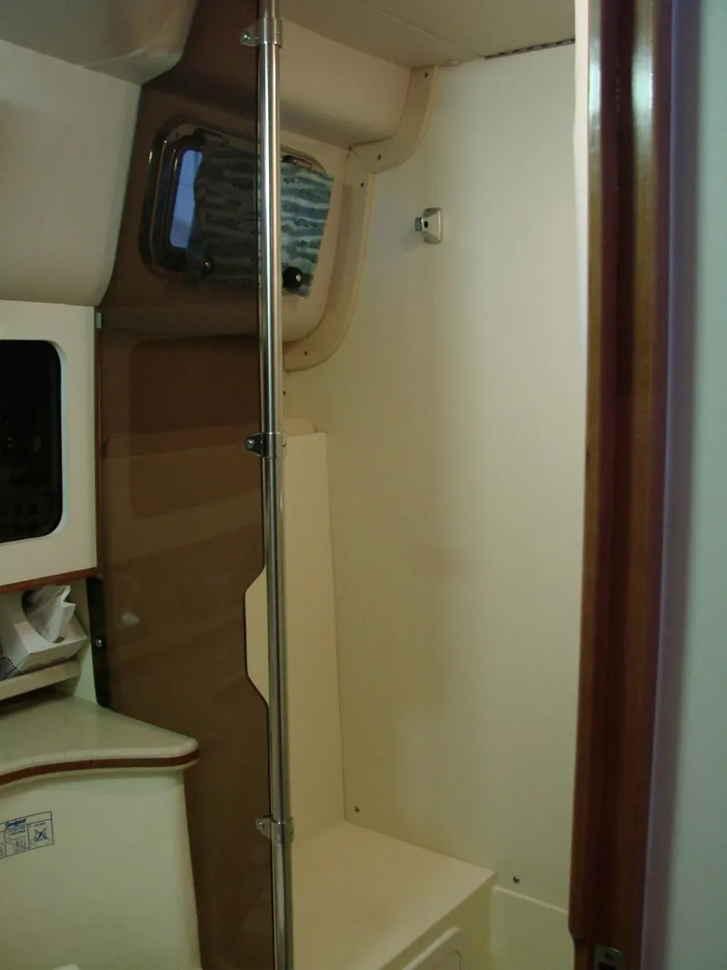 Slide: The Image of 2005 Albin Tournament Express interior cabin with window and storage. - 45