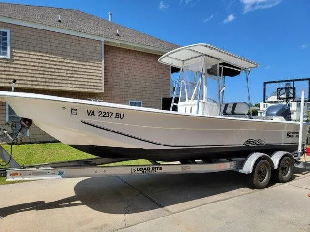 The Image of 2011 Carolina Skiff 258 DLV boat on trailer, parked in driveway. - 0