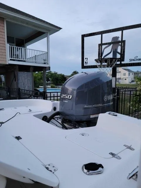 Slide: The Image of 2011 Carolina Skiff 258 DLV with Yamaha 250 engine near a basketball hoop. - 1