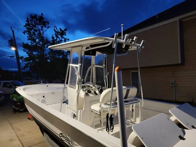Slide: The Image of 2011 Carolina Skiff 258 DLV boat at dusk, parked in driveway. - 7