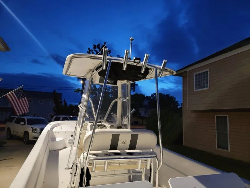 Slide: The Image of 2011 Carolina Skiff 258 DLV boat at dusk, parked in residential driveway. - 8