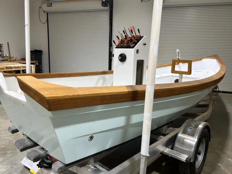 Slide: The Image of 2024 Caribiana Maracas boat on trailer in garage setting. - 11