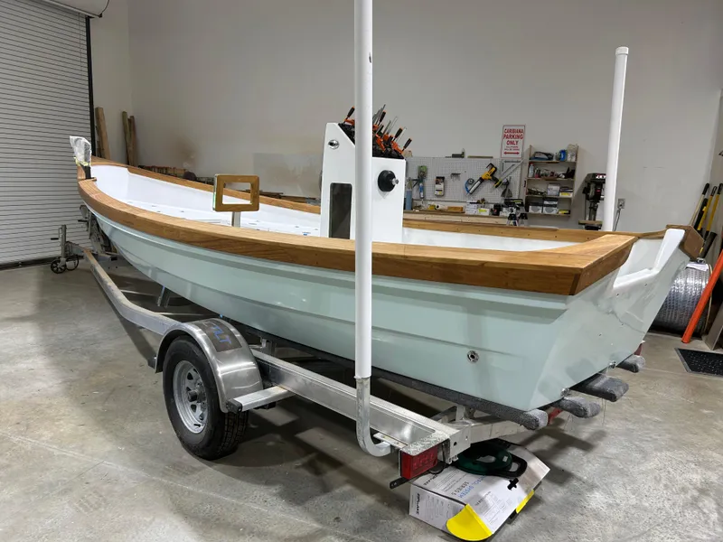 Slide: The Image of 2024 Caribiana Maracas boat on trailer in workshop setting. - 12