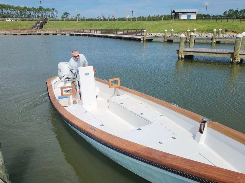 Slide: The Image of 2024 Caribiana Maracas boat in a marina, featuring sleek design and wooden accents. - 3