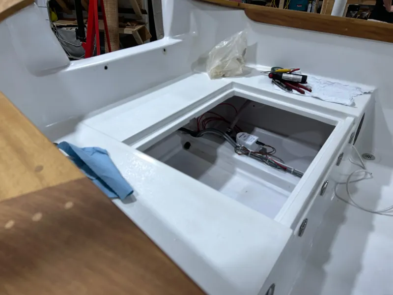 Slide: The Image of 2024 Caribiana Maracas boat interior with open compartment and tools. - 7