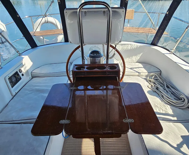 Slide: The Image of Cockpit of 2005 Nonsuch 33 sailboat with wooden table and seating. - 11