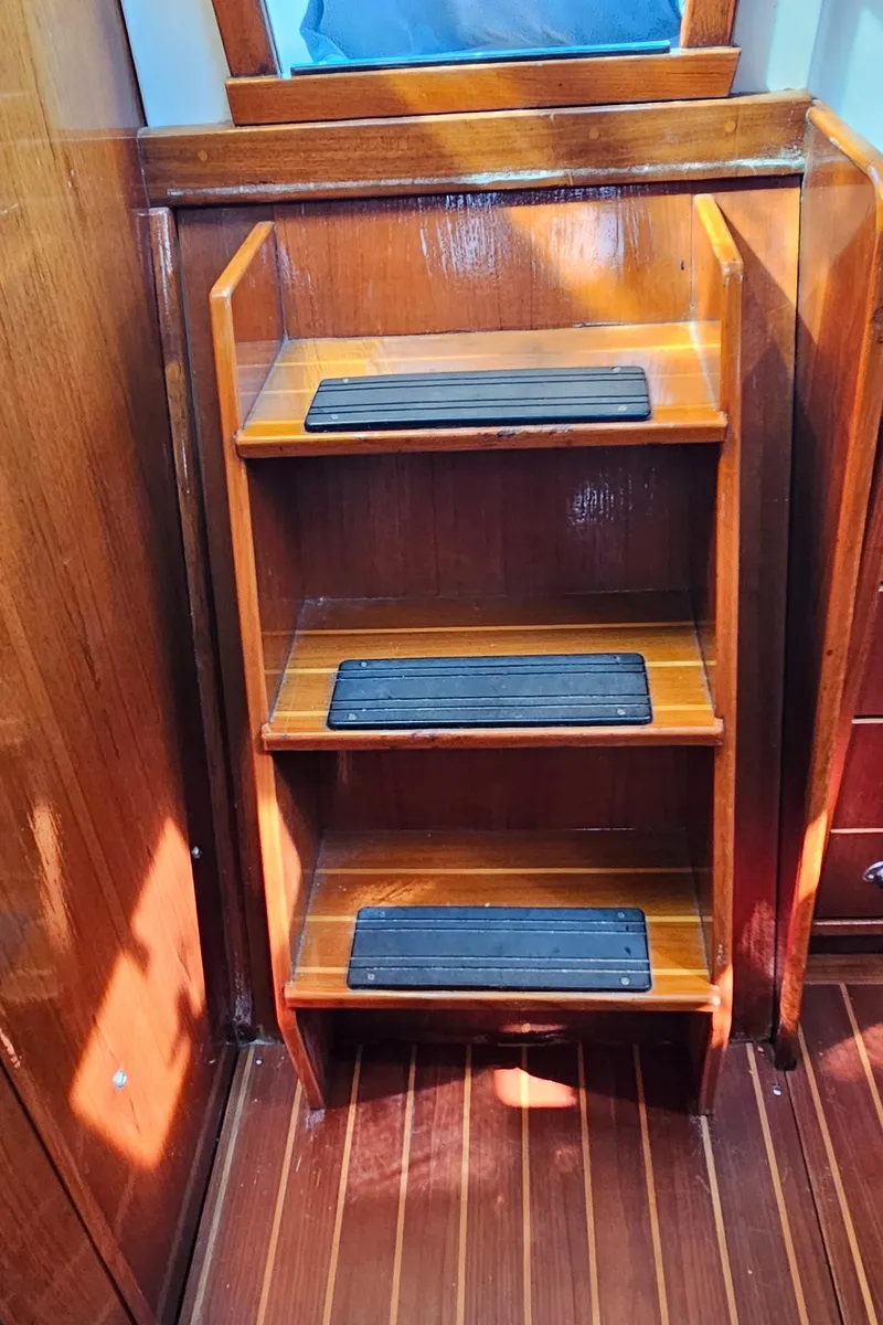 Slide: The Image of Wooden steps with non-slip pads on a 2005 Nonsuch 33 boat interior. - 21