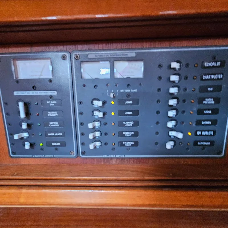 Slide: The Image of Electrical control panel on a 2005 Nonsuch 33 boat, featuring various switches and indicators. - 23