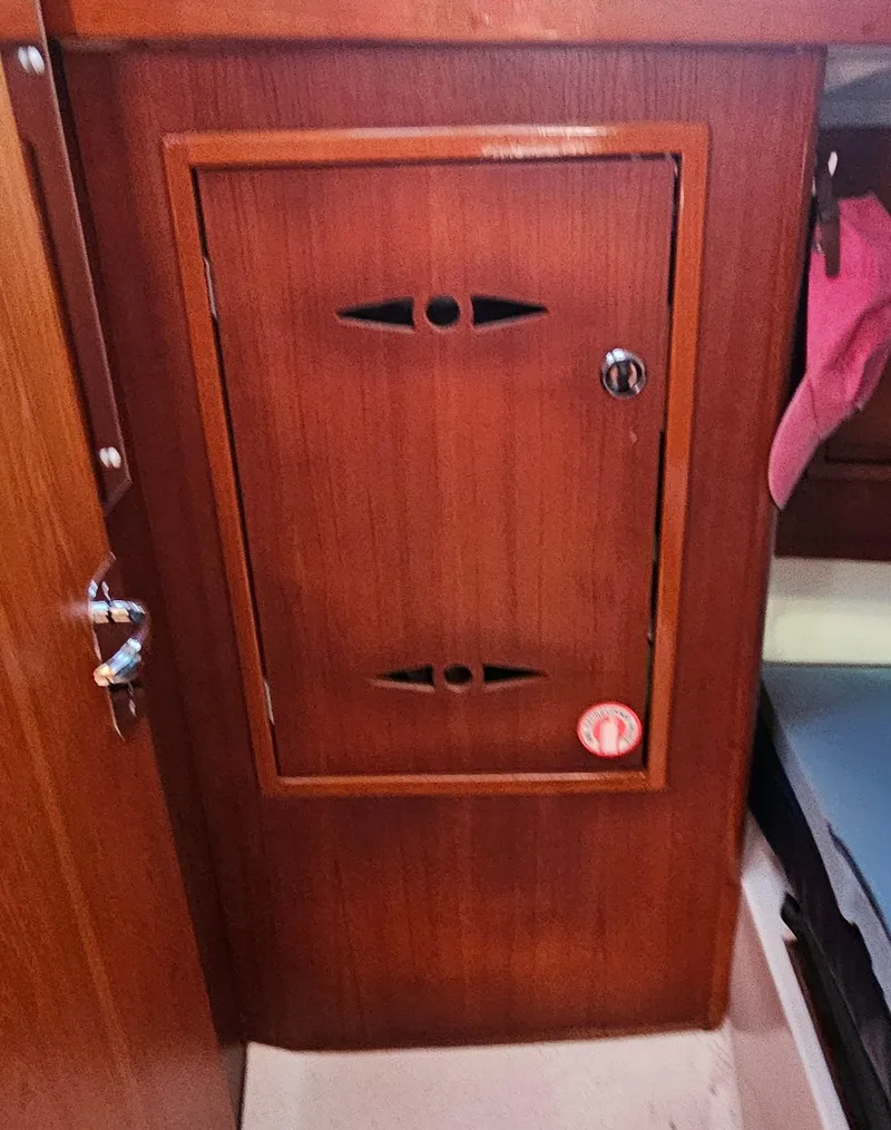 Slide: The Image of Wooden cabinet door inside a 2005 Nonsuch 33 sailboat interior. - 28