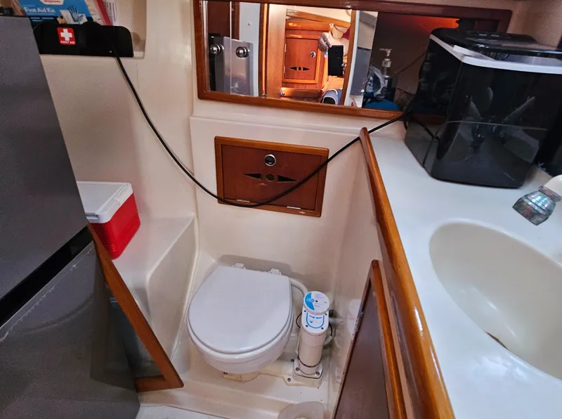 Slide: The Image of Compact bathroom in a 2005 Nonsuch 33 yacht, featuring a toilet and sink. - 29