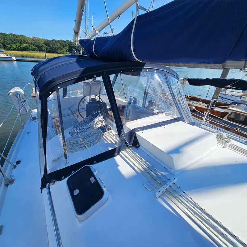 Slide: The Image of Nonsuch 33 sailboat, 2005 model, with blue canopy and clear panels, docked on a sunny day. - 3