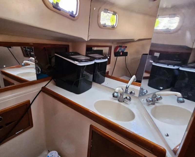 Slide: The Image of Interior of 2005 Nonsuch 33 boat bathroom with sink and mirrors. - 30