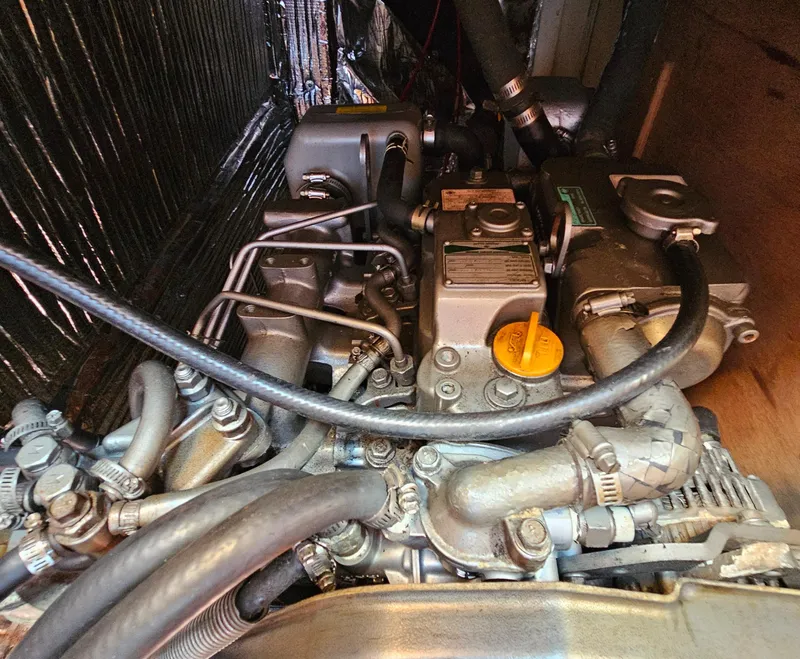 Slide: The Image of Engine compartment of a 2005 Nonsuch 33 sailboat, showcasing detailed mechanical components. - 32