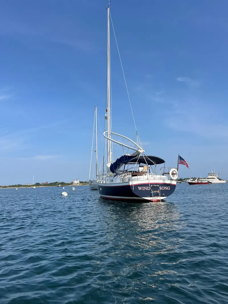 Slide: The Image of Sailboat "Windsong," Nonsuch 33, 2005 model, anchored on calm water under clear blue sky. - 35