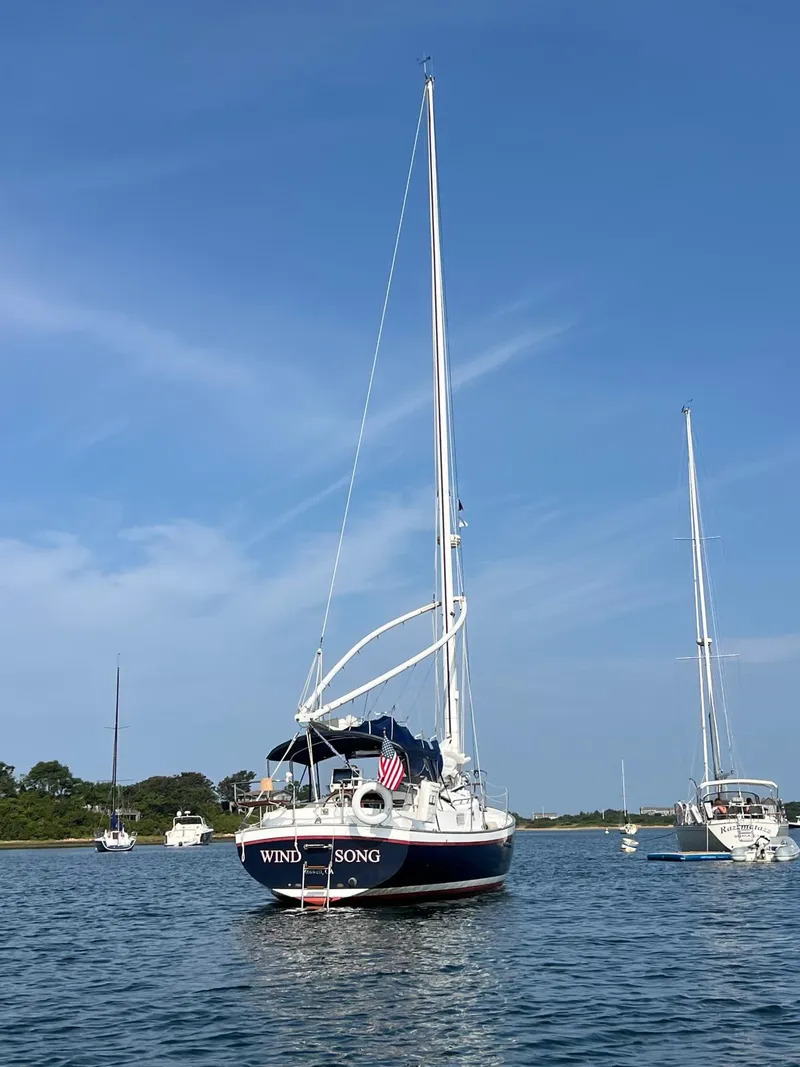 Slide: The Image of Sailboat Nonsuch 33, 2005 model, anchored on calm water under clear blue sky. - 36
